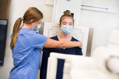 Two radiography students practicing x-ray skills in the lab